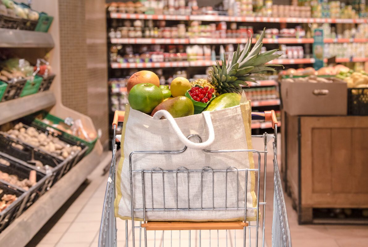 Eco bag with different fruits and vegetables in a shopping cart